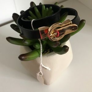 Black leather Wrap bracelet with gold buckle.